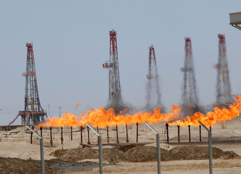 © Reuters. FILE PHOTO: Flames emerge from a pipeline at Rumaila oilfield in Basra