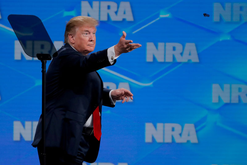 © Reuters. FILE PHOTO: President Trump tosses a pen after signing an executive order at the annual NRA meeting in Indianapolis