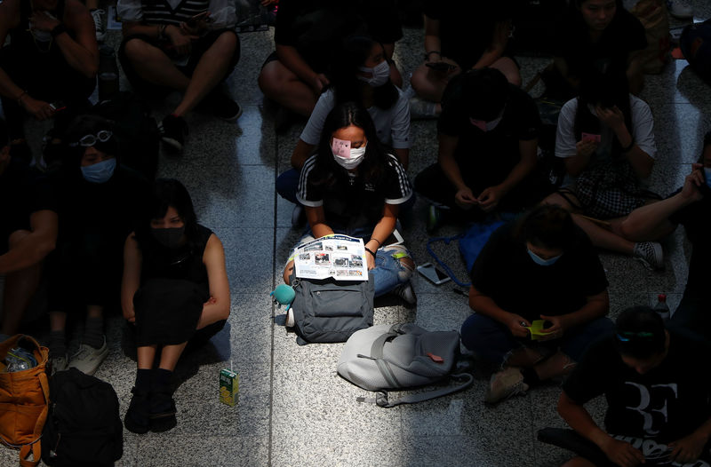 Hong Kong airport grinds to a halt as protests swell