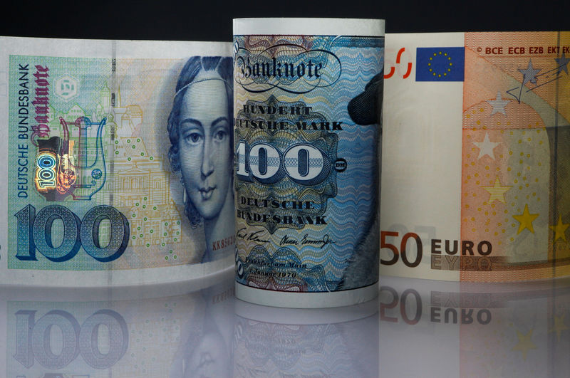 © Reuters. FILE PHOTO: One hundred Mark notes and fifty Euros note are seen in this photo illustration taken in Berlin