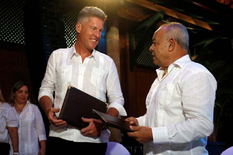 © Reuters. David Cutter, President of Global Supply and Procurement of British beverage giant Diageo, looks on Juan Gonzalez Escalona, President of the state-run Cuba Ron, signing a joint venture to market Santiago de Cuba rum, in Havana