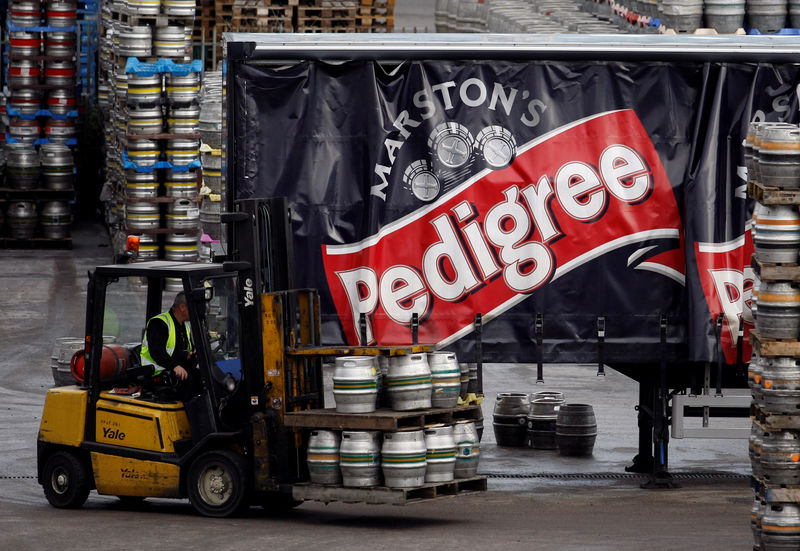 © Reuters. FILE PHOTO: A forklift truck driver loads a lorry with beer at Marston's Brewery in Burton upon Trent