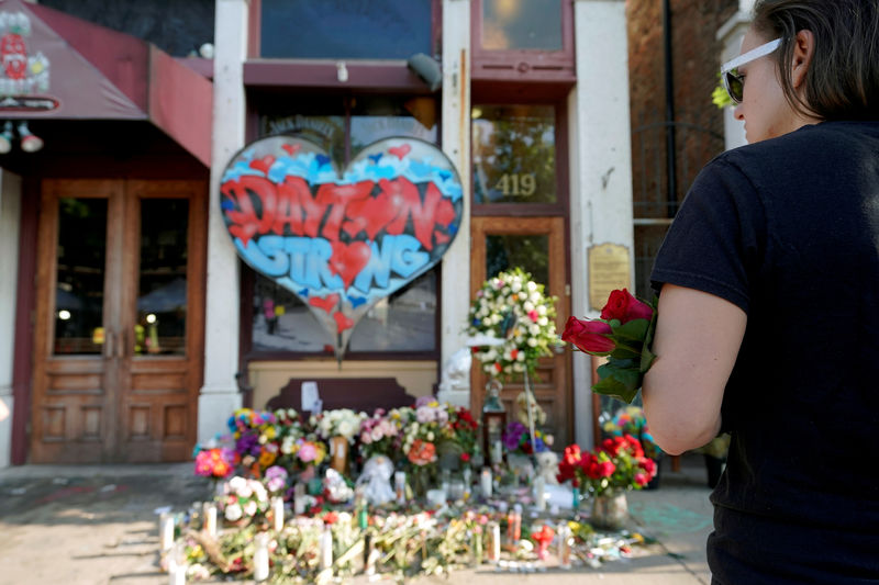 © Reuters. FILE PHOTO: A Oregon District resident stands at a memorial for those killed during Sunday morning's a mass shooting in Dayton