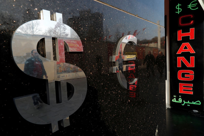 © Reuters. Signs of U.S. dollar and Euro are seen at a currency exchange office in Istanbul