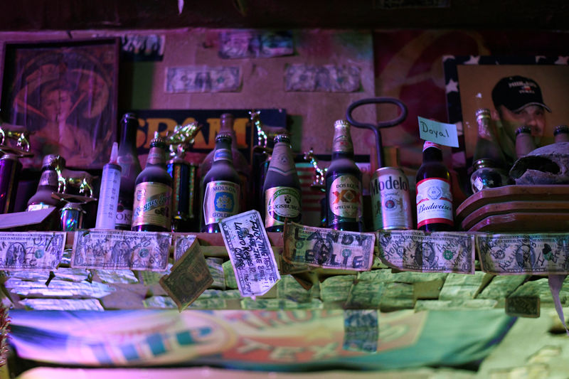 © Reuters. Dollar bills signed by past customers are seen at The Field Office bar in Midland