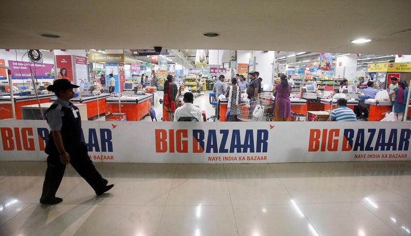 © Reuters. FILE PHOTO: A security personnel walks past the Big Bazaar retail store in Mumbai