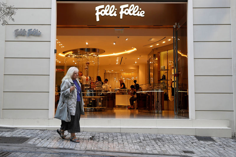 © Reuters. FILE PHOTO: A woman walks past a Folli Follie store in central Athens