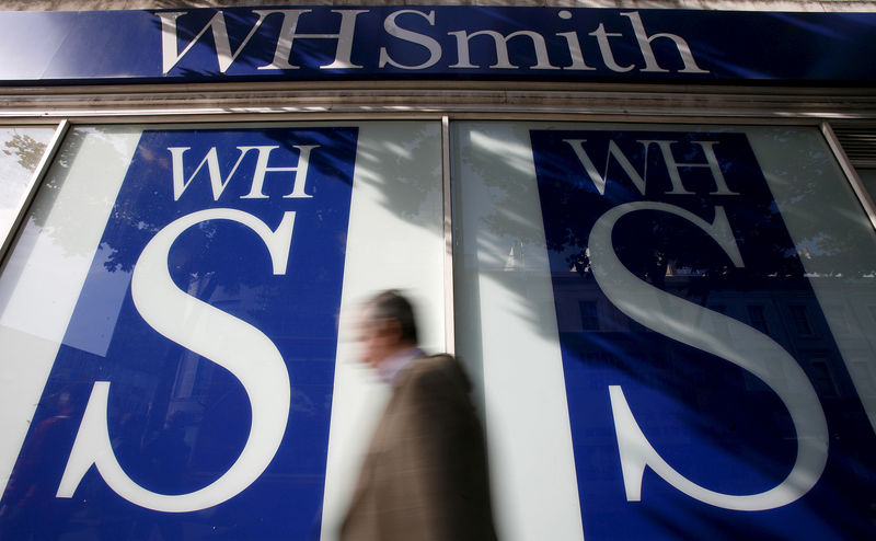 © Reuters. File photo of pedestrians walking past a WH Smith shop in London