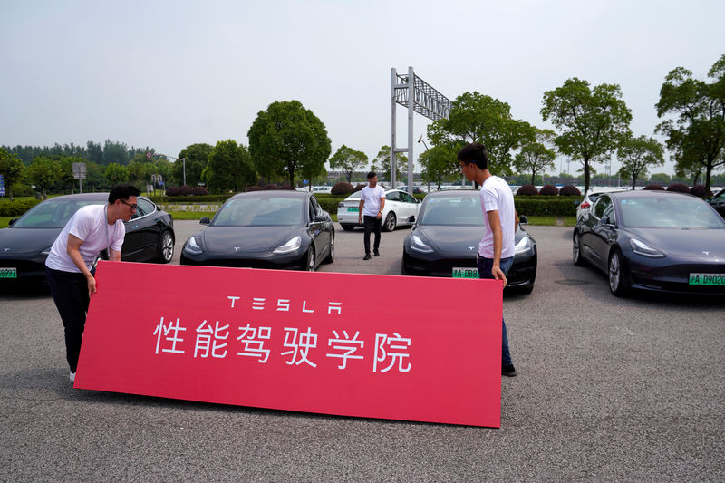 © Reuters. People attend a Tesla performance driving school promotional event at Shanghai International Circuit