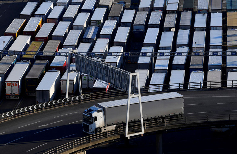 © Reuters. FILE PHOTO: A lorry is driven past dozens of others parked after traveling by ferry between Britain and France at the Port of Dover
