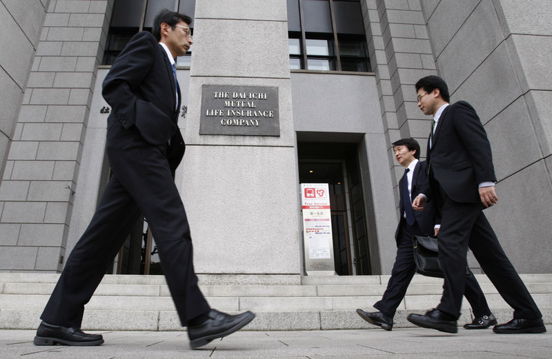 © Reuters. FILE PHOTO - Businessmen walk past the Dai-ichi Mutual Life Insurance headquarters in Tokyo