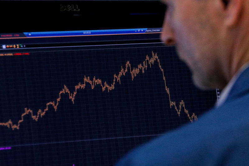 © Reuters. Specialist trader works at his station on the floor at the NYSE in New York