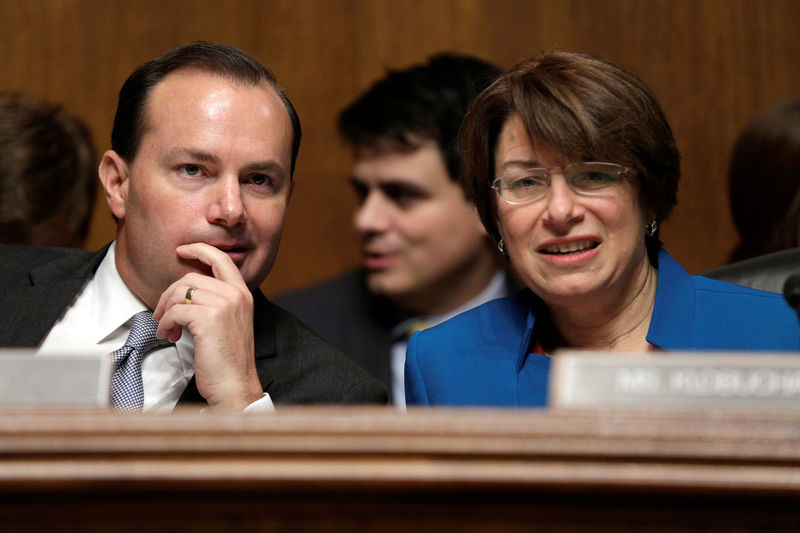 © Reuters. Chairman of the Senate Judiciary Committee Antitrust Subcommittee Mike Lee speaks with Amy Klobuchar before a hearing on the proposed deal between AT&T and Time Warner in Washington.