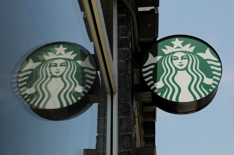 © Reuters. A Starbucks logo hangs outside of one of the 8,000 Starbucks-owned American stores that will close around 2 p.m. local time on Tuesday as a first step in training 175,000 employees on racial tolerance in the Brooklyn borough of New York