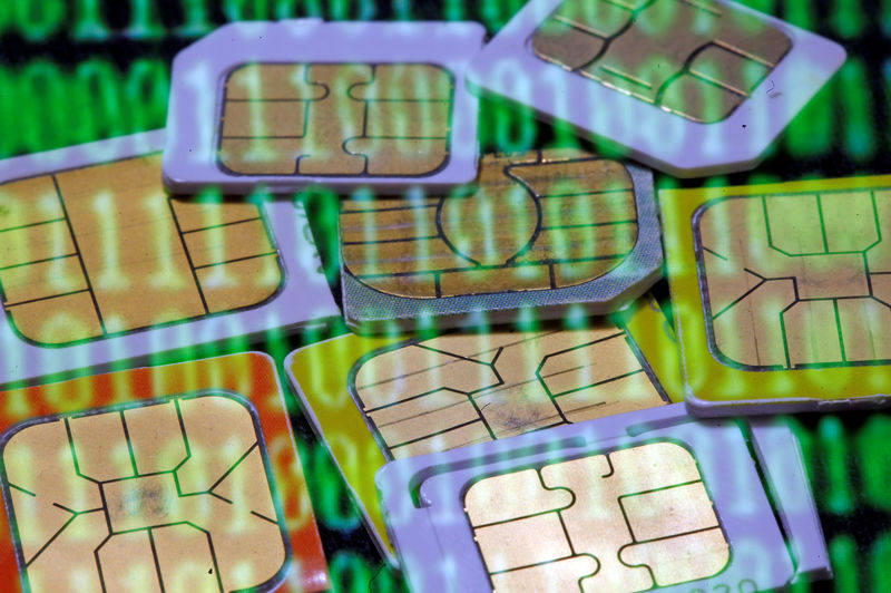 © Reuters. FILE PHOTO: SIM cards are reflected on a monitor showing binary digits in this photo illustration taken in Sarajevo