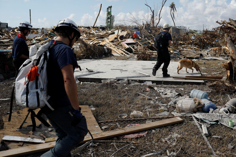 © Reuters. Personnel of the Canadian Burnaby Firefighters Search & Rescue Task Force search for the dead in the destroyed the Mudd neighbourhood after Hurricane Dorian hit the Abaco Islands in Marsh Harbour