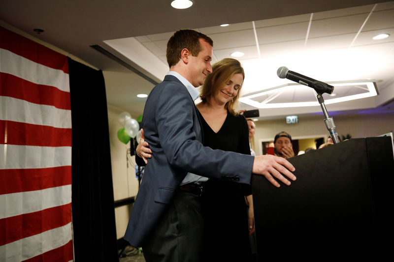 © Reuters. Dan McCready, the Democratic candidate in the special election for North Carolina's 9th Congressional District, pauses after delivering his concession speech following his loss in the contest, while his wife Laura accompanies him, in Charlotte, North Carol