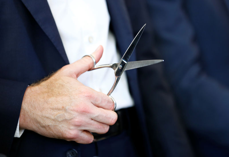 © Reuters. Swiss food giant Nestle CEO Schneider holds scissors during the inauguration ceremony of the Nestle Institute of Packaging Sciences in Lausanne