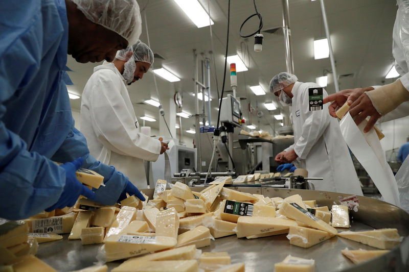 © Reuters. Workers separate packaged parmesan cheese in the warehouse at Ambriola Co Inc in West Caldwell, New Jersey