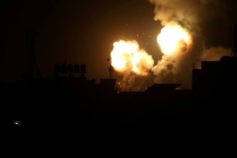 © Reuters. Flame and smoke are seen during Israeli air strikes in the southern Gaza Strip