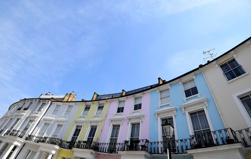 © Reuters. FILE PHOTO: Houses are seen painted in various colours in a residential street in London