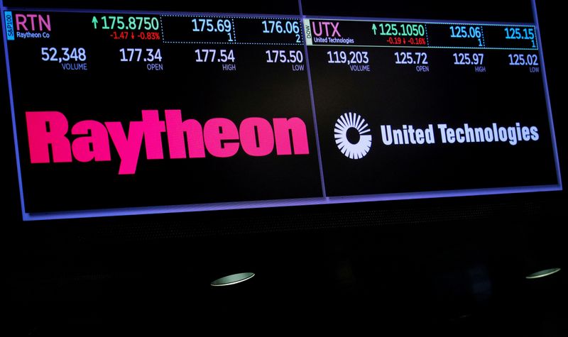 © Reuters. FILE PHOTO: A screen shows the logos and trading information for defense contractor Raytheon Co, and United Technologies Corp. on the floor at the NYSE in New York