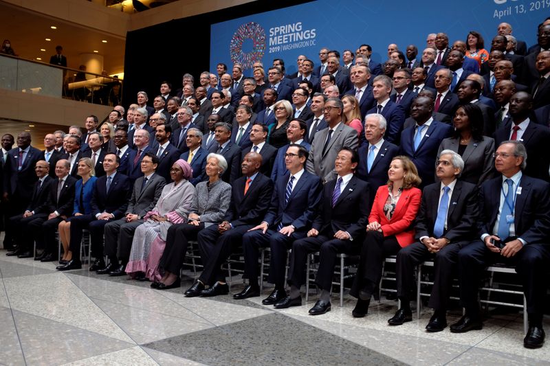 © Reuters. FILE PHOTO: Central bank governors and other global finance officials sit for a group photo at the IMF and World Bank's 2019 Annual Spring Meetings, in Washington