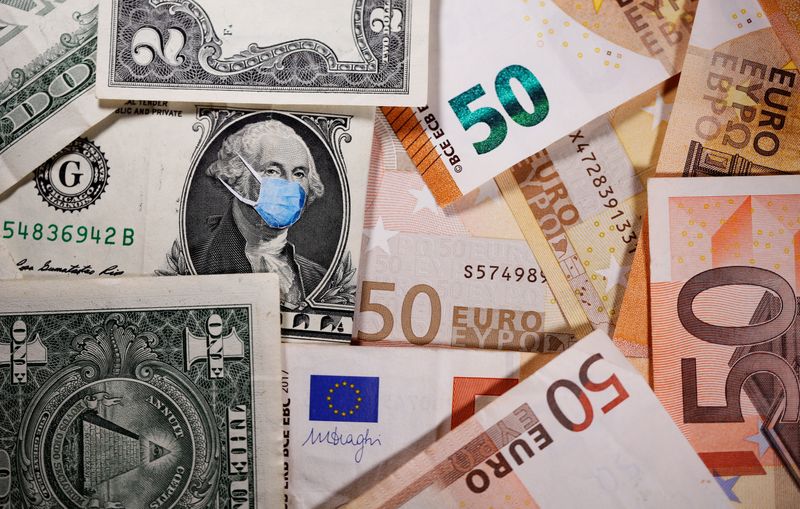 &copy; Reuters. George Washington con una mascherina disegnata su una banconota da un dollaro vicino a banconote in euro