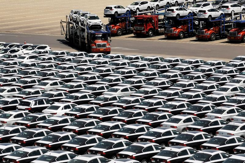 &copy; Reuters. FILE PHOTO: Carrier trailer transports newly manufactured cars at a port in Dalian