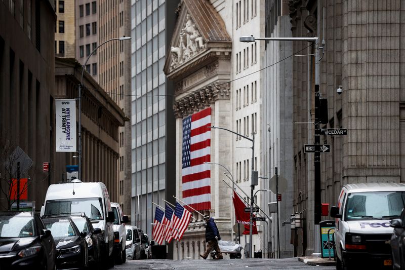 &copy; Reuters. A man crosses a nearly deserted Nassau street in front of the New York Stock Exchange (NYSE) in the financial district of lower Manhattan in New York