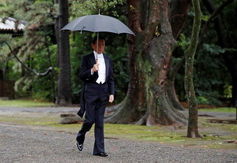 &copy; Reuters. FILE PHOTO: Japan&apos;s Finance Minister Taro Aso arrives at the ceremony site where Emperor Naruhito will report the conduct of the enthronement ceremony at the Imperial Sanctuary inside the Imperial Palace in Tokyo