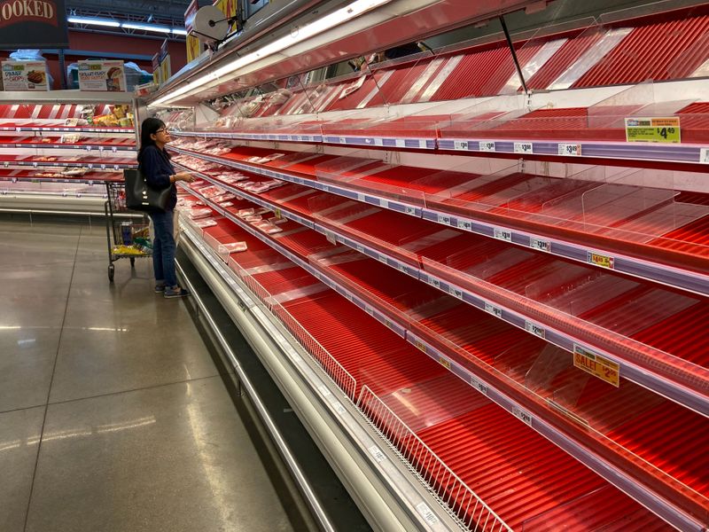 &copy; Reuters. FILE PHOTO: A shopper picks over the few items remaining in the meat section, as people stock up on supplies amid coronavirus fears, at an Austin, Texas