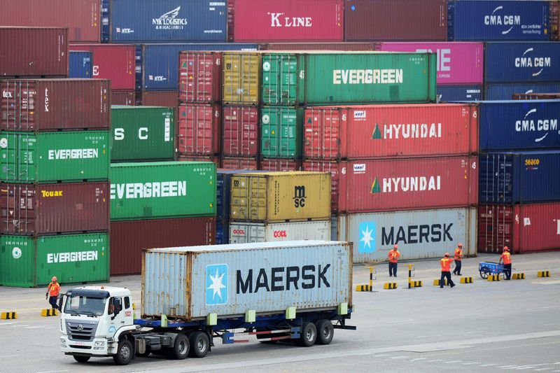 &copy; Reuters. FILE PHOTO:  Truck transports a container at a port in Qingdao, Shandong