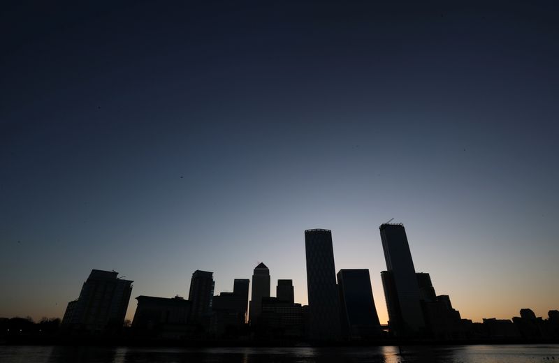 &copy; Reuters. FILE PHOTO:  The sun rises behind the Canary Wharf financial district in London