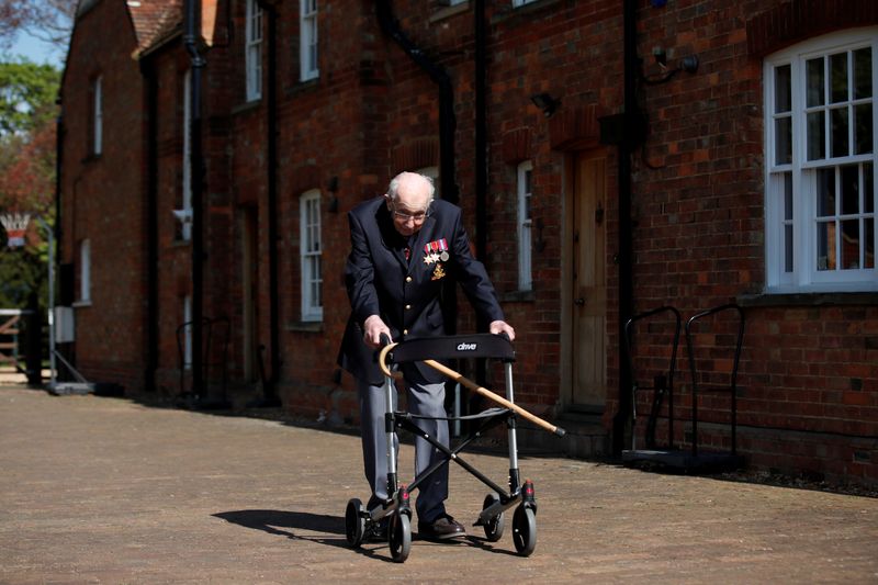 &copy; Reuters. Retired British Army Captain Moore walks to raise money for health workers