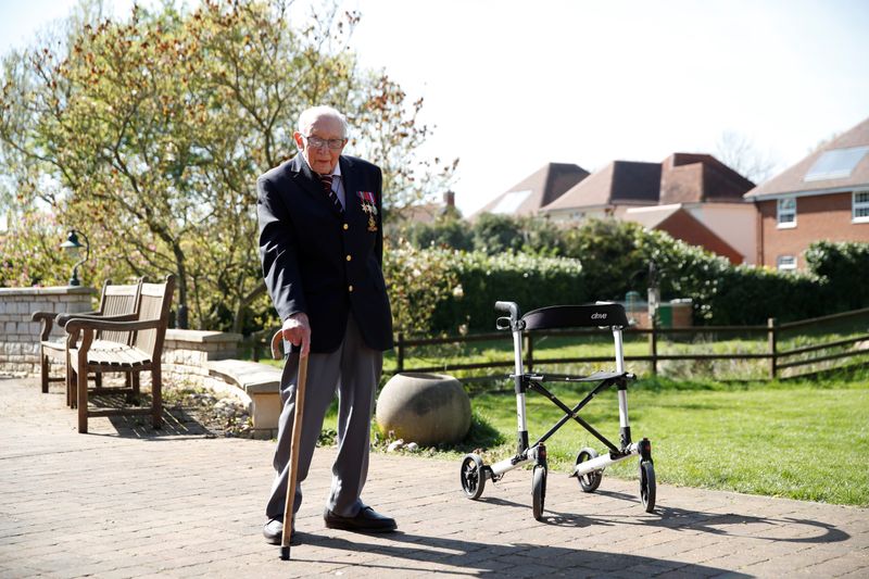 © Reuters. Retired British Army Captain Moore walks to raise money for health workers