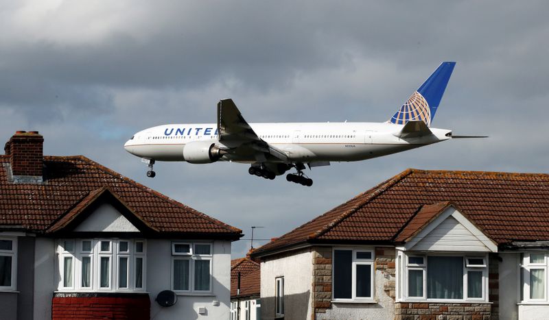&copy; Reuters. A United Airlines passenger aircraft arrives over the top of residential houses to land at Heathrow Airport in west London
