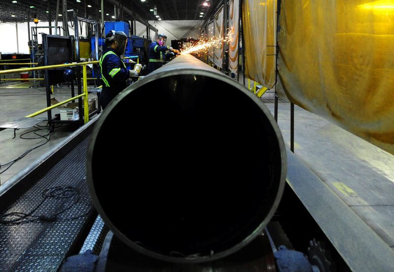 &copy; Reuters. Workers are seen at Bri-Steel Manufacturing, a manufacturer and distributer of large diameter seamless steel pipes, in Edmonton