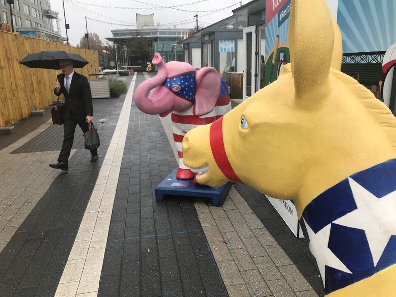 &copy; Reuters. A commuter walks past U.S. political party symbols at Metro station in Reston, Virginia