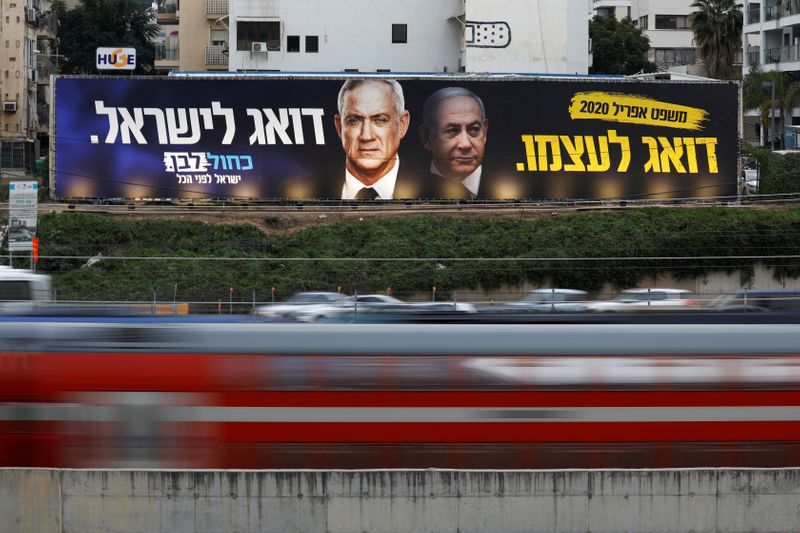 &copy; Reuters. FILE PHOTO: Traffic moves past a Blue and White party election campaign poster, depicting party leader Benny Gantz, and Israeli Prime Minister Benjamin Netanyahu, in Tel Aviv