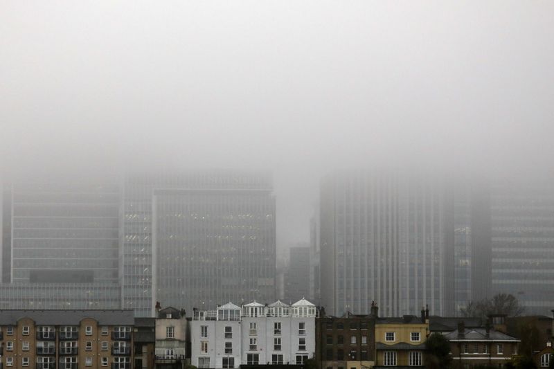 &copy; Reuters. A low fog engulfs the skyscrapers of the financial district of Canary Wharf