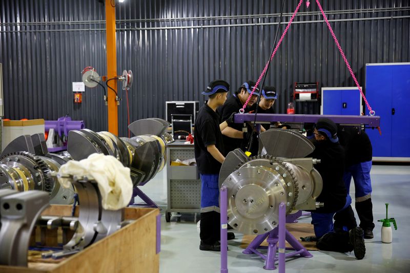 &copy; Reuters. FILE PHOTO: Employees work at a engine factory of CSSC Wartsila Engine (Shanghai) Co. Ltd  in Shanghai