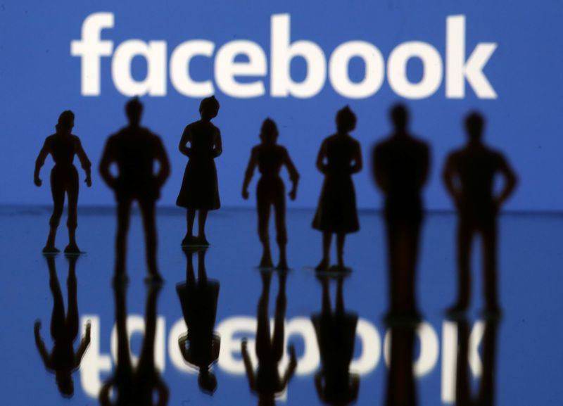&copy; Reuters. Small toy figures are seen in front of Facebook logo in this illustration picture
