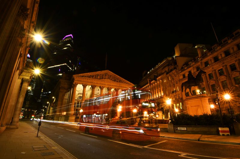 &copy; Reuters. An empty bus is driven through the quiet streets outside the Bank of England in the early hours in London