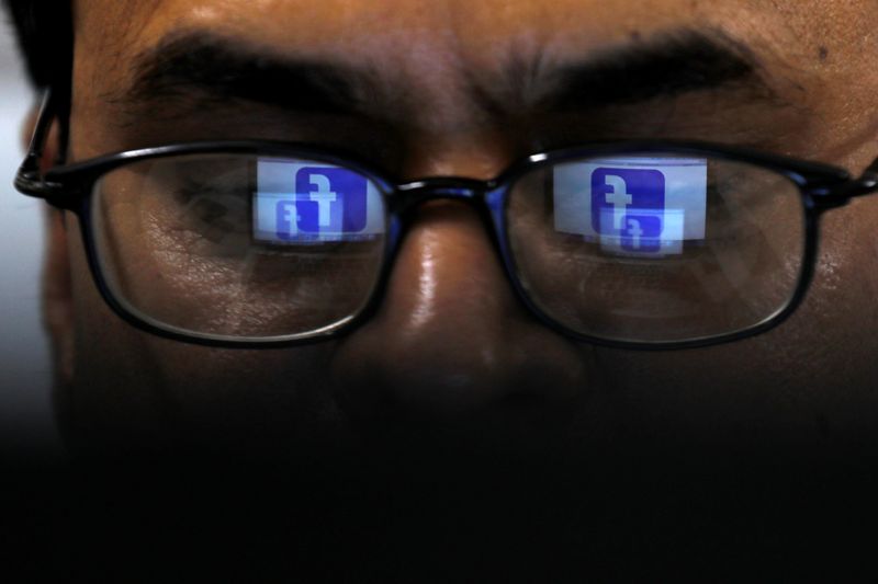 &copy; Reuters. Facebook logo is reflected in glasses in this picture illustration