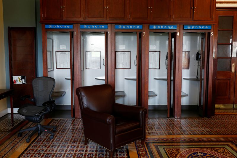 © Reuters. Phone booths remain empty inside of the Senate press gallery ahead of House vote on coronavirus relief bill in Washington