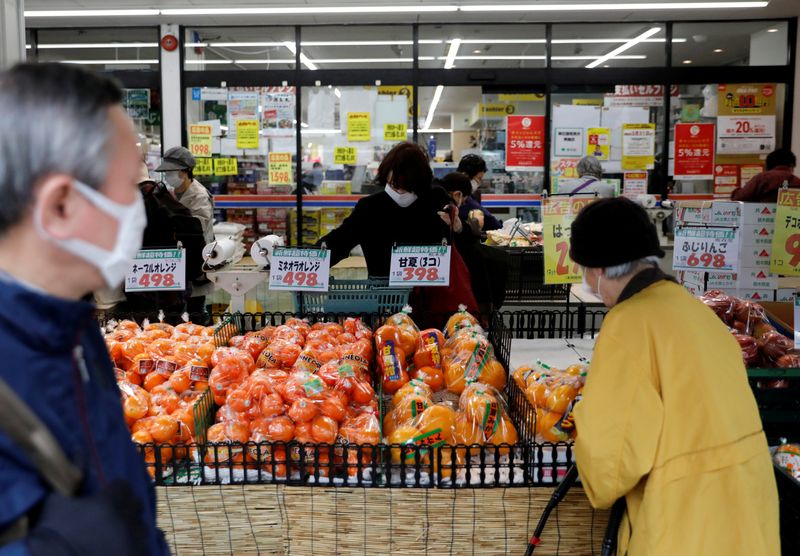 &copy; Reuters. Shoppers wearing protective face masks, following an outbreak of the coronavirus disease, are seen at a supermarket in Tokyo, Japan
