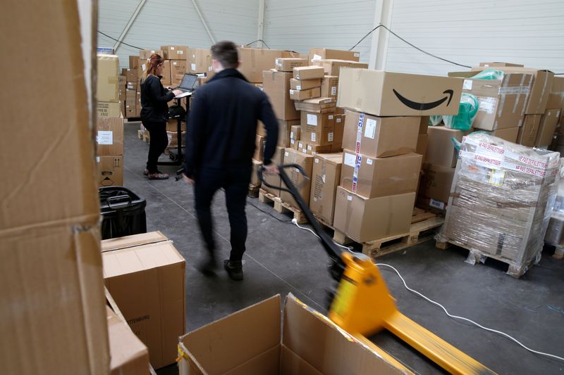 © Reuters. An employee prepares an order for Amazon at Porona warehouse in Bruay-sur-l'Escaut