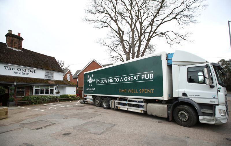 &copy; Reuters. A Green King lorry makes a delivery at The Old Bell pub in Harpenden as the number of coronavirus cases grow around the world