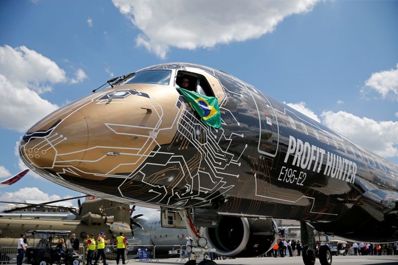 &copy; Reuters. FILE PHOTO: An Embraer E195-2 is seen on display, sporting a livery combining a lion&apos;s head with an integrated circuit design, during the 53rd International Paris Air Show at Le Bourget Airport near Paris